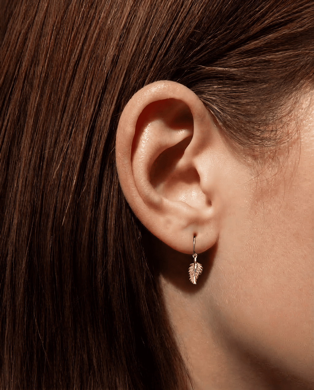 The Feather- 18K yellow gold hoop earrings and a feather charm